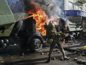 An anti-government protester throws a Molotov cocktail in Kiev